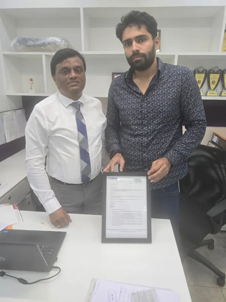 Mohammed Zaid presenting a certificate with a business professional at an hdfc office.