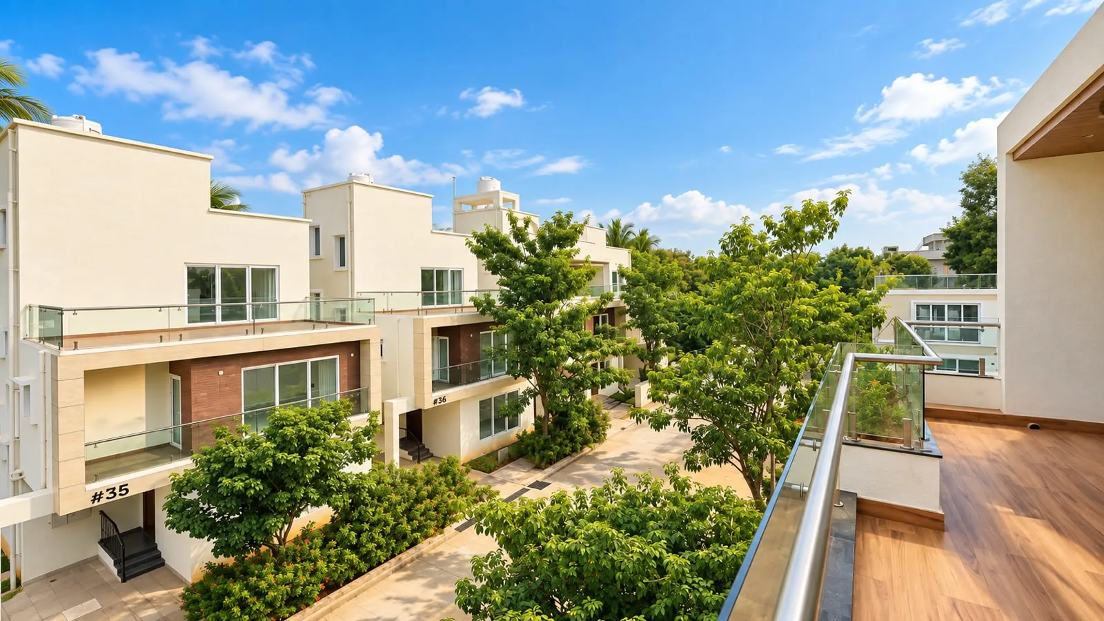 Modern residential villas with landscaped gardens and glass balconies